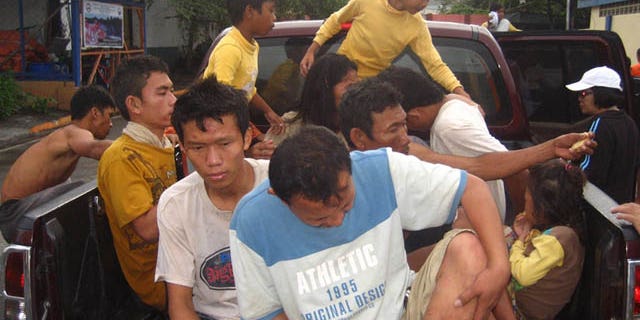 December 18, 2011: Rescued residents board a vehicle at Iligan city, southern Philippines.