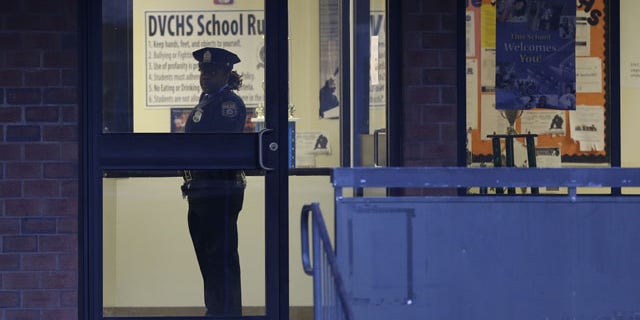 January 17, 2014: Police stands guard the Delaware Valley Charter School in Philadelphia, after two students were shot by another student. (AP)
