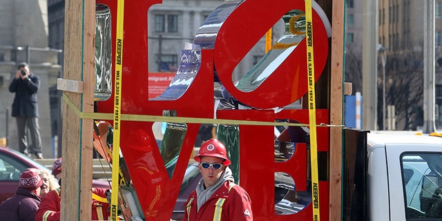 "LOVE", the famous 1976 Robert Indiana sculpture, is parked in front of John F. Kennedy Plaza before reinstallation, Tuesday Feb. 13, 2018 in Philadelphia. The sculpture was removed for repairs a year ago while its home, the downtown park, was going through a renovation. (AP Photo/Jacqueline Larma)
