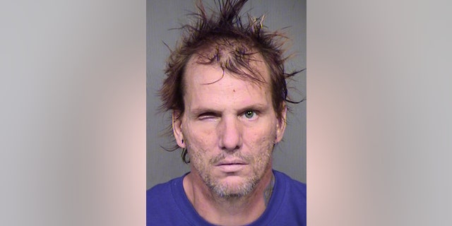 This booking photo provided by the Maricopa County Sheriff's Office shows 43-year-old Kenneth Dale Wakefield. Investigators say Wakefield killed and decapitated his 49-year-old wife, Trina Heisch, and their two dogs and then inflicted injuries on himself, including a severed left forearm and a missing eye. He was booked into Maricopa County jail Saturday afternoon, Aug. 1, 2015, on one count of first-degree murder and two counts of animal cruelty. (Maricopa County Sheriff's Office via AP)