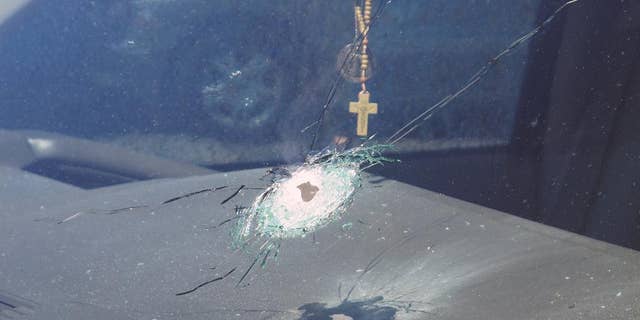 This undated photo released by the Arizona Department of Public Safety shows a bullet hole in the windshield of a vehicle in Phoenix. Four vehicles traveling on the same freeway in the heart of Phoenix have been struck by gunshots in the last week, and the state police agency is appealing for information from the public as it conducts what it says is a robust investigation. (Arizona Department of Public Safety via AP)