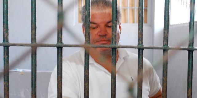 March 1: Norwegian Stein Havard Dokset stands behind bars at the Phuket police station after he was arrested in southern Thailand.