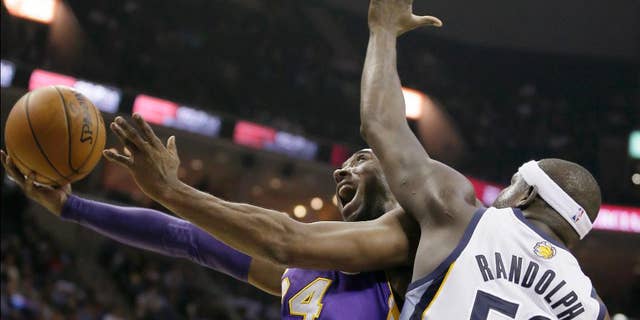 FILE - In this Dec. 17, 2013, file photo, Los Angeles Lakers' Kobe Bryant goes to the basket in front of Memphis Grizzlies' Zach Randolph (50) during the first half of an NBA basketball game in Memphis, Tenn. Bryant’s 19th season gets started Tuesday, Oct. 28, 2014, when the Lakers open at home against the Houston Rockets. What he has left in the tank after two injury-filled years might be one of the biggest questions heading into the season, with the Lakers already being widely written off in the loaded Western Conference and Bryant hardly expected to regain the elite form that he displayed for so long. (AP Photo/Danny Johnston, File)