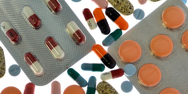 Pharmaceutical tablets and capsules in foil strips are arranged on a table in this picture illustration taken in Ljubljana September 18, 2013. Picture taken September 18. REUTERS/Srdjan Zivulovic (SLOVENIA - Tags: HEALTH) - RTX15K29