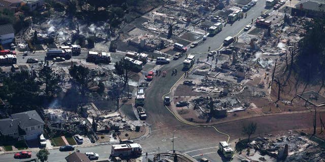 File-In this Sept.10, 2010 file photo firefighters and rescue crews work amongst damage caused by a pipeline explosion and an ensuing massive fire in a residential neighborhood in San Bruno, Calif. (AP Photo/Jeff Chiu,File)