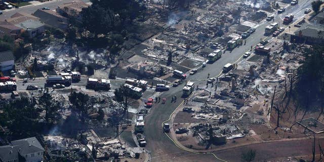 File-In this Sept.10, 2010 file photo firefighters and rescue crews work amongst damage caused by a pipeline explosion and an ensuing massive fire in a residential neighborhood in San Bruno, Calif. (AP Photo/Jeff Chiu,File)