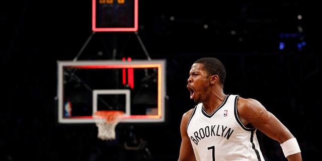Brooklyn Nets guard Joe Johnson (7) celebrates after hitting the game winning shot for a 107-105 victory in double overtime against the Detroit Pistons after their NBA basketball game at Barclays Center, Friday, Dec. 14, 2012, in New York. (AP Photo/John Minchillo)