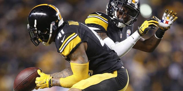 Dec 28, 2014; Pittsburgh, PA, USA; Pittsburgh Steelers defensive back Antwon Blake (41) and cornerback Brice McCain (25) celebrate a fumble recovery by Blake against the Cincinnati Bengals during the fourth quarter at Heinz Field. The Steelers won 27-17. Mandatory Credit: Charles LeClaire-USA TODAY Sports
