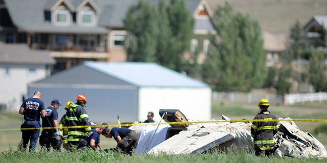 August 31, 2014: Police and firefighters work on the scene where three people were killed and two others injured after an airplane crashed in a field northwest of the main runway at Erie Municipal Airport while coming in for a landing in Erie, Colo. (AP Photo/The Daily Camera, Cliff Grassmick)