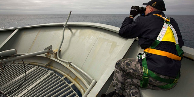 In this March 22, 2014 photo provided by the Australian Department of Defence (ADF), a lookout is stationed on bow of HMAS Success during the search in the southern Indian Ocean for signs of the missing Malaysia Airlines Flight MH370. The desperate, multinational hunt for Flight 370 resumed again Wednesday, March 26 across a remote stretch of the Indian Ocean after fierce winds and high waves that had forced a daylong halt eased considerably. (AP Photo/ADF, James Whittle) EDITORIAL USE ONLY