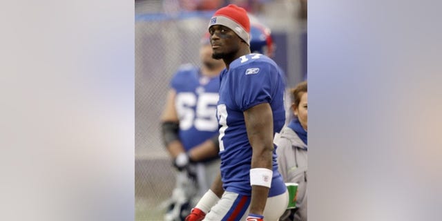In this Nov. 16, 2008 file photo, New York Giants wide receiver Plaxico Burress (17) watches from the sidelines against the Baltimore Ravens during the first half of an NFL football game in East Rutherford, N.J. The New York Giants released Super Bowl hero Plaxico Burress on Friday, April 3, 2009, a little more than four months after the talented but troubled wide receiver accidentally shot himself in the thigh in a New York City nightclub. (AP Photo/Rob Carr, File)