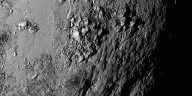 Tuesday, July 14, 2015 Image provided by NASA on Wednesday shows a region near Pluto's equator with a range of mountains captured by the New Horizons spacecraft.