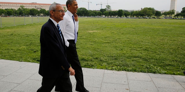 U.S. President Barack Obama walks on the Ellipse with White House counselor John Podesta near the White House in Washington May 21, 2014.