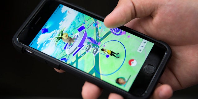 TOKYO, JAPAN - JULY 22: A man plays Pokemon Go game on a smartphone on July 22, 2016 in Tokyo, Japan. The Japanese version of the game app Pokemon Go was released on July 22, 2016. Japan McDonalds' 3,000 restaurants in Japan will be turned into Pokemon gyms in collaboration with the fast-food chain. (Photo by Tomohiro Ohsumi/Getty Images)