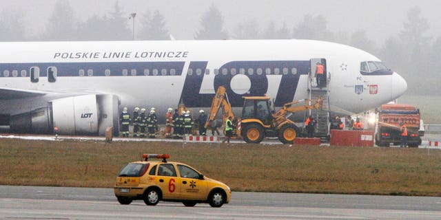 Nov. 2, 2011: Staff of the Frederic Chopin airport in Warsaw, Poland, prepare to move a Boeing 767 of Polish LOT airlines to unblock one of the airport's two runways and allow for air traffic.