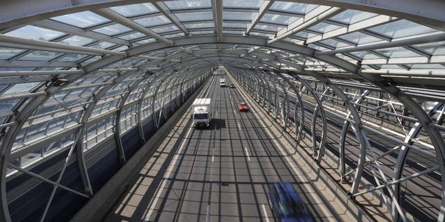 Cars drive through a soundproof tunnel covering a highway in Warsaw, Poland, Wednesday, April 30, 2014, one of the many investments built with the help of European Union funds. Poland joined the European Union a decade ago, a time that made monumental changes in the country as well as in some other former Soviet satellite states in east and central Europe. (AP Photo/Alik Keplicz)