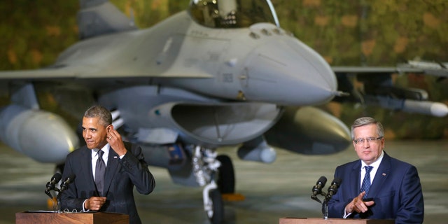 June 3, 2014: U.S. President Barack Obama and Poland's President Bronislaw Komorowski make statements and meet with U.S. and Polish troops at an event featuring four F-16 fighter jets, two American and two Polish, as part of multinational military exercises, in Warsaw. (AP Photo/Charles Dharapak)