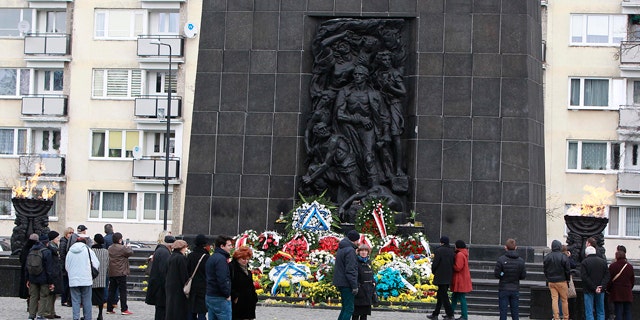 April 19, 2015: People gather in front of the monument to the Heroes of the Ghetto, on the 72nd anniversary of the Warsaw Ghetto Uprising, in Warsaw. (AP Photo/Czarek Sokolowski)