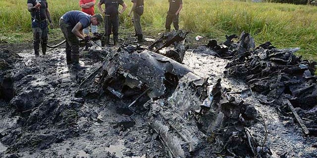 Aug. 23, 2015: Firefighters are retrieving the remains of a Soviet WW II fighter-bomber plane from muddy riverbed near Wyszogrod, Poland.