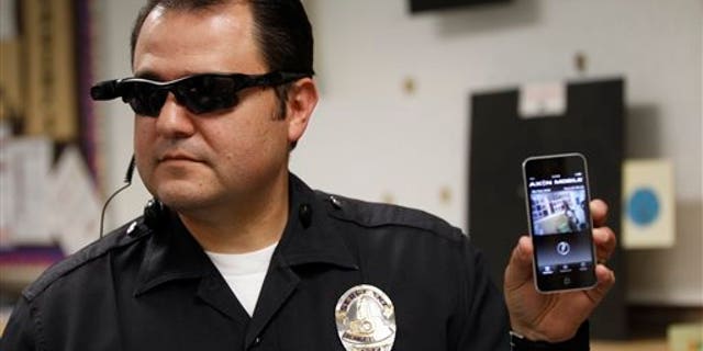 This Jan. 15, 2014 file photo shows Los Angeles Police Sgt. Daniel Gomez demonstrating a video feed from his camera into his cellphone as on-body cameras are demonstrated for the media in Los Angeles. Thousands of police agencies have equipped officers with cameras to wear with their uniforms, but theyve frequently lagged in setting policies on how theyre used, potentially putting privacy at risk and increasing their liability. As officers in one of every six departments across the nation now patrols with tiny lenses on their chests, lapels or sunglasses, administrators and civil liberties experts are trying to envision and address troublesome scenarios that could unfold in front of a live camera. (AP Photo/Damian Dovarganes)