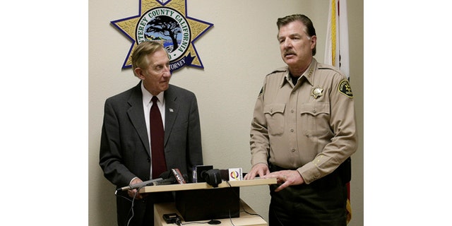 Monterey County District attorney Dean Flippo, left, and Monterey County Sheriff Scott Miller answer questions during a news conference, Tuesday, Feb. 25, 2014, in Salinas, Calif. Flippo said the six officers, including the recently retired police chief and the acting chief, have been arrested, in connection to a scheme to steal more than 200 cars from poor Hispanic people. (AP Photo/The Monterey County Herald, Vern Fisher)