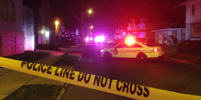 Nov. 23, 2015: Police block off an area after a fatal shooting in Columbus, Ohio. Police said a married couple and their 7-year-old son were shot and wounded while the couple's 12-year-old daughter was wounded (AP Photo/Andrew Welsh-Huggins)