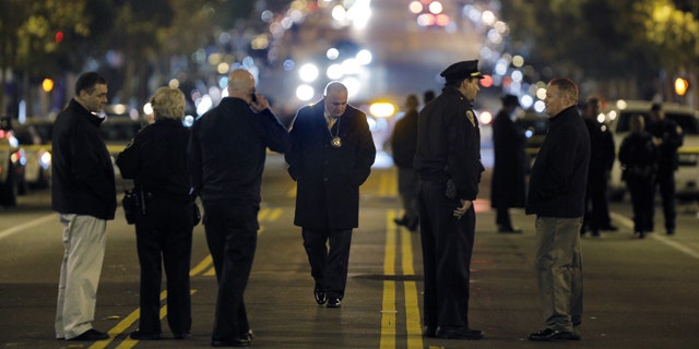 Jan: 4, 2015: Police investigators search for evidence after an officer-involved shooting at the San Francisco Police Mission Station in San Francisco. Officers shot and killed a man who brandished what appeared to be a handgun but was actually an air gun after they told him to leave a restricted parking lot. (AP Photo/San Francisco Chronicle, Carlos Avila Gonzalez)