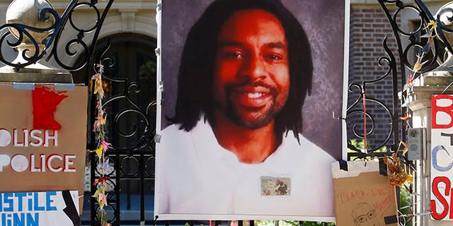 A memorial including a photo of Philando Castile adorns the gate to the governor's residence in St. Paul, Minn.