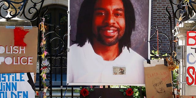 A memorial including a photo of Philando Castile adorns the gate to the governor's residence in St. Paul, Minn.
