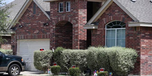 No trespassing signs are visible at the house Tuesday, Sept. 1, 2015, where deputies fatally shot Gilbert Flores, in Northwest Bexar County, Texas, near San Antonio, last Friday. A Texas prosecutor says a second video has emerged that gives authorities a “very clear view” of a confrontation between deputies and Flores who had his hands raised before he was shot and killed. (John Davenport/The San Antonio Express-News via AP) RUMBO DE SAN ANTONIO OUT; NO SALES; MANDATORY CREDIT