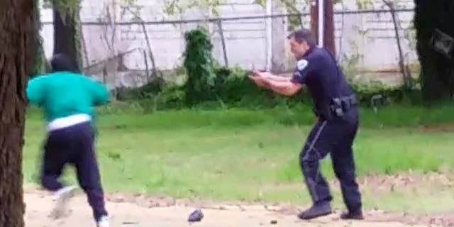 FILE - In this April 4, 2015, file photo, from video provided by Attorney L. Chris Stewart representing the family of Walter Lamer Scott, Scott appears to be running away from City Patrolman Michael Thomas Slager, right, in North Charleston, S.C. Slager was charged with murder on Tuesday, April 7, hours after law enforcement officials viewed the dramatic video that appears to show him shooting a fleeing Scott several times in the back. (AP Photo/Courtesy of L. Chris Stewart, File)