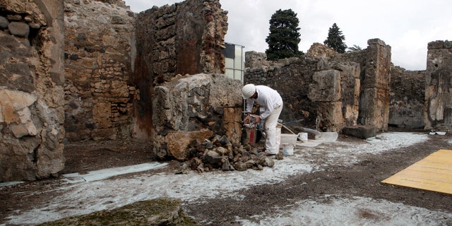 Feb. 6, 2013: A restorer works in the ancient Roman city Pompeii, which was buried in AD 79 by an eruption of the Vesuvius volcano.