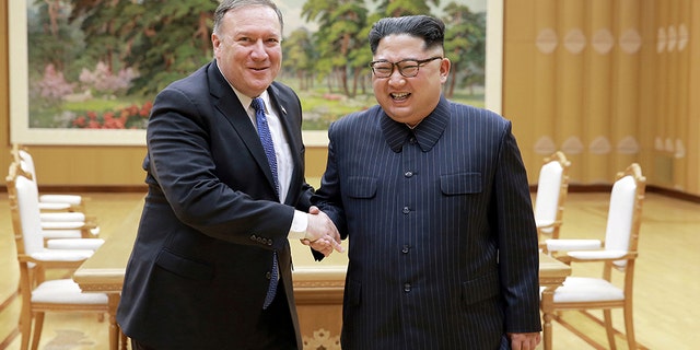 North Korean leader Kim Jong Un (right) shakes hands with U.S. Secretary of State Mike Pompeo (left), who left North Korea early Wednesday morning with the three American detainees, whom the Trump administration had referred to as “hostages.” (KCNA)