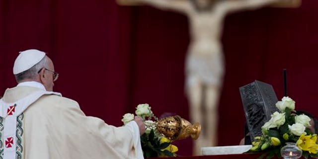 Pope Francis blesses the relics of St. Peter as he celebrates mass for the end of the Year of Faith, in St. Peter's Square at the Vatican, Sunday, Nov. 24, 2013. (AP Photo/Andrew Medichini)