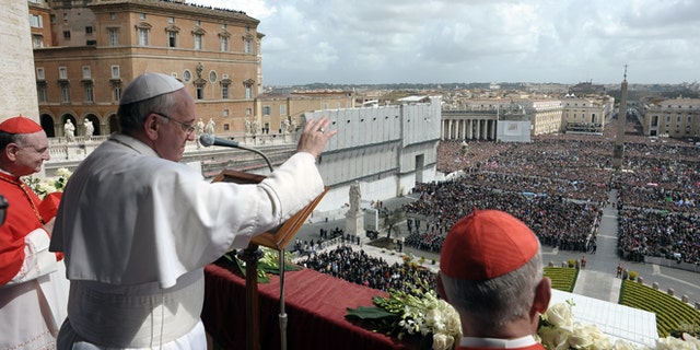 In this photo provided by the Vatican newspaper L'Osservatore Romano, Pope Francis delivers the Urbi et Orbi (to the city and to the world) blessing, in St. Peter's Square at the Vatican, Sunday, March 31, 2013. Pope Francis celebrated his first Easter Sunday Mass as pontiff in St. Peter's Square, packed by joyous pilgrims, tourists and Romans and bedecked by spring flowers.Wearing cream-colored vestments, Francis strode onto the esplanade in front of St. Peter's Basilica and took his place at an altar set up under a white canopy. (AP Photo/L'Osservatore Romano)