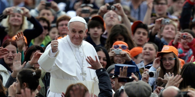 Pope Francis waves to faithful as he is driven through the crowd with his popemobile in St. Peter's Square prior to the start of his weekly general audience at the Vatican, Wednesday, April 10, 2013. (AP Photo/Alessandra Tarantino)