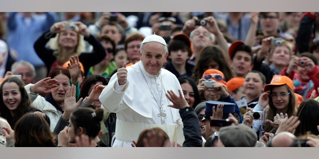 Pope Francis waves to faithful as he is driven through the crowd with his popemobile in St. Peter's Square prior to the start of his weekly general audience at the Vatican, Wednesday, April 10, 2013. (AP Photo/Alessandra Tarantino)