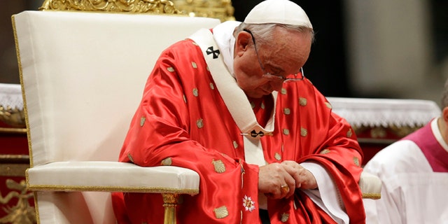 Pope Francis celebrates a mass of Pentecost in St. Peter's Basilica, at the Vatican, Sunday, May 24, 2015. Pope Francis urged pilgrims filling St. Peter's Square on Pentecost Sunday to take "the heroic examples" of a slain El Salvadoran bishop and an Italian nun who worked in Kenya who were beatified this weekend. (AP Photo/Gregorio Borgia)