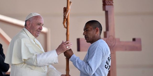 Pope Francis receives a cross made by an inmate at the CeReSo n. 3 prison in Ciudad Juarez, Mexico, Wednesday, Feb. 17, 2016. The pontiff is wrapping up his trip to Mexico on Wednesday with a visit in the prison, just days after a riot in another lockup killed 49 inmates, and a stop at the Texas border when immigration is a hot issue for the U.S. presidential campaign. (Gabriel Bouys/Pool photo via AP)