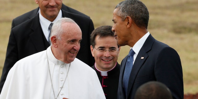U.S. President Barack Obama chats with Pope Francis as he welcomes him upon his arrival at Joint Base Andrews outside Washington Sept. 22, 2015.