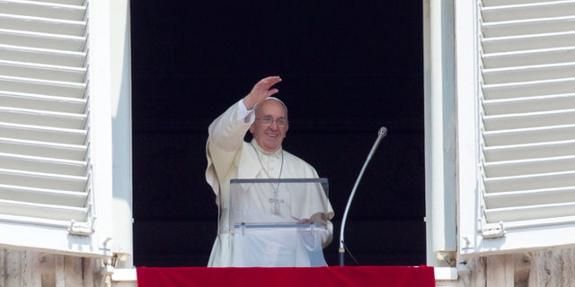 Aug. 9, 2015: Pope Francis waves before reciting the Angelus noon prayer from his window overlooking St. Peter's Square at the Vatican, in Italy.
