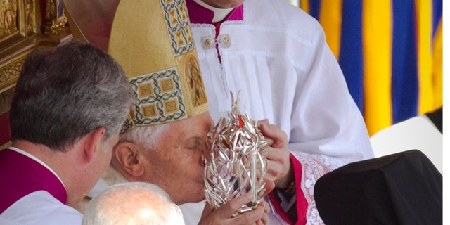 May 1: Pope Benedict XVI kisses the glass reliquary containing the blood of late Pope John Paul II, during the beatification ceremony in St. Peter's Square at the Vatican in the fastest beatification in modern times.