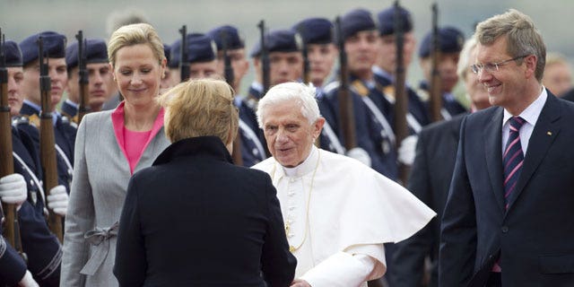 September 22: German Chancellor Angela Merkel, front, welcomes Pope Benedict XVI, center, after his arrival at the Tegel airport in Berlin, Germany.
