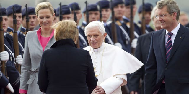 September 22: German Chancellor Angela Merkel, front, welcomes Pope Benedict XVI, center, after his arrival at the Tegel airport in Berlin, Germany.