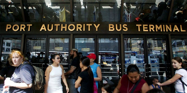 NEW YORK - AUGUST 15: Stranded travellers gather outside the closed Port Authority Bus Terminal during a massive blackout August 15, 2003 in New York City. Power is slowly returning to certain parts of the city. (Photo by Mario Tama/Getty Images)
