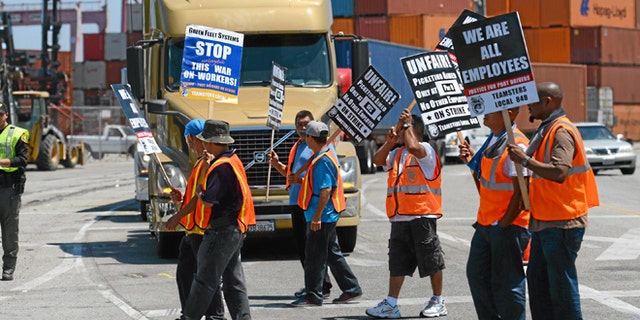 This July 8, 2014 file photo shows members of the Teamsters Union picketing at the Port of Long Beach, Calif.