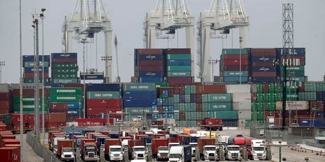 FILE - In this Tuesday, Feb. 17, 2015, file photo, cargo trucks wait in line at the Port of Long Beach, in Long Beach, Calif. Maritime companies that are locked in a contract dispute with West Coast dockworkers took their case directly to rank-and-file longshoremen Wednesday, Feb. 18, as negotiators for both sides struggled to reach a deal and break cargo gridlock which has stalled billions of dollars of international trade. (AP Photo/Jae C. Hong, File)
