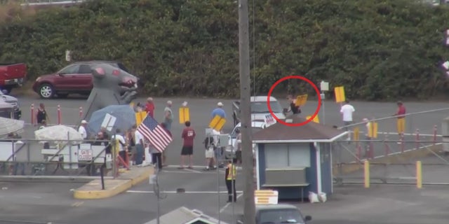 In this Port of Vancouver surveillance video footage from 2013, a member from ILWU Local 4 is seen trying to open the door of a state grain inspectors vehicle after confronting the official for trying to enter the facility.
