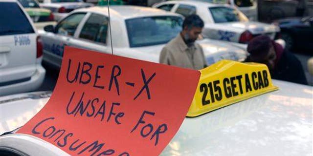 Drivers with the Taxi Workers Alliance of Pennsylvania protest Uber.