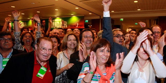June 5: Supporters of the center-right Social Democratic Party, PSD, react to the exit polls results shown on TV screens seconds after voting closed in Portugal at a hotel in Lisbon. Exit polls showed the PSD unseating the ruling Socialist Party.